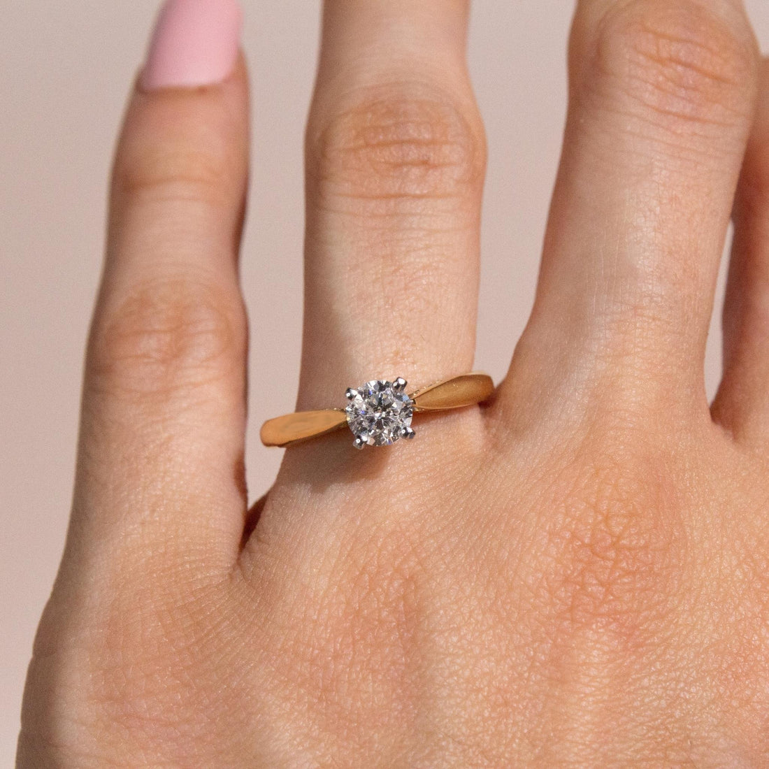 0.60 carat diamond ring on finger, solitaire diamond engagement ring